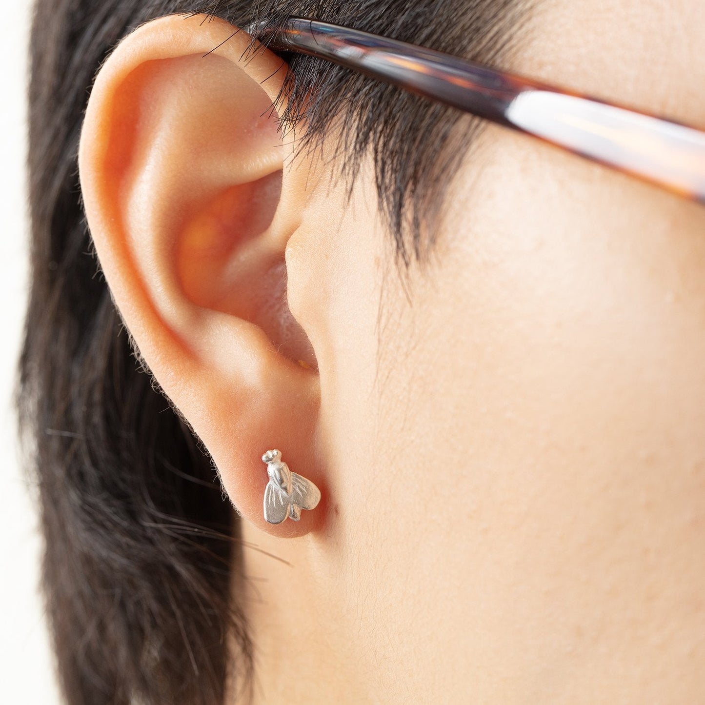 Model wearing Petite Abeille earrings by Betsy Barron in right ear