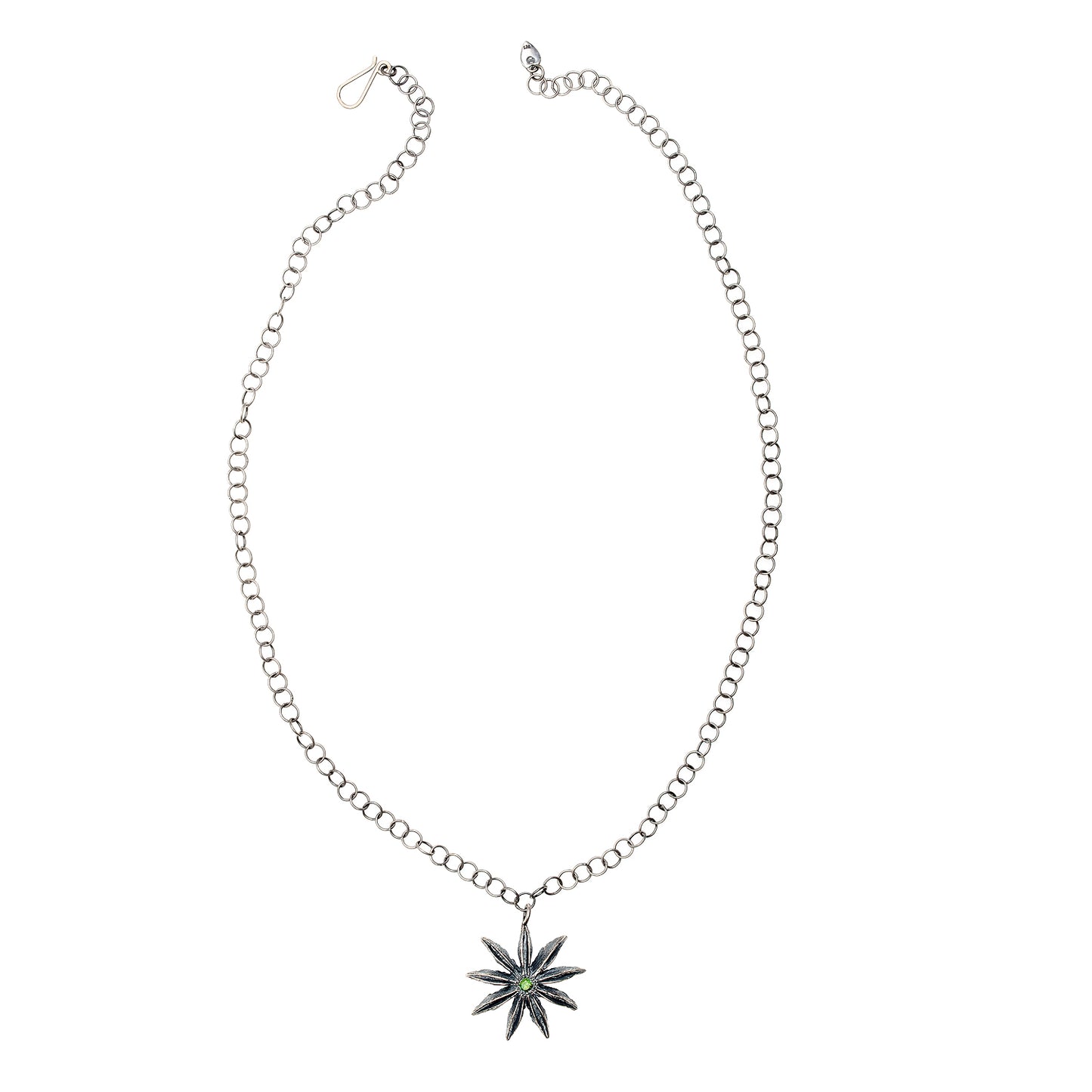 Top-down view of sterling silver Star Anise Necklace with emerald