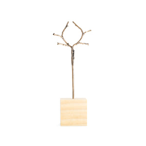 Bronze double hair stick, shown in wood block display