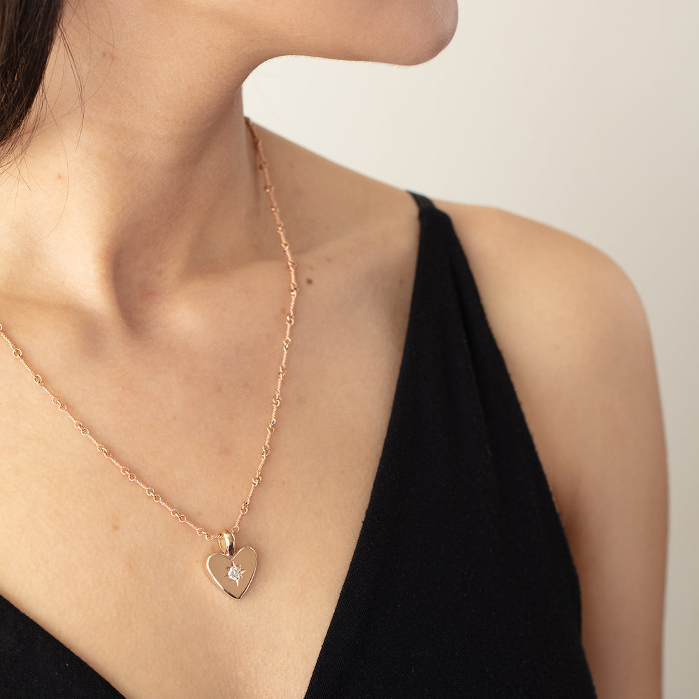 Model wearing Detail view of small classic heart necklace with 3.5mm Antique White Diamond
