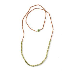 Top-down view of Vacation Necklace with jade green garnets
